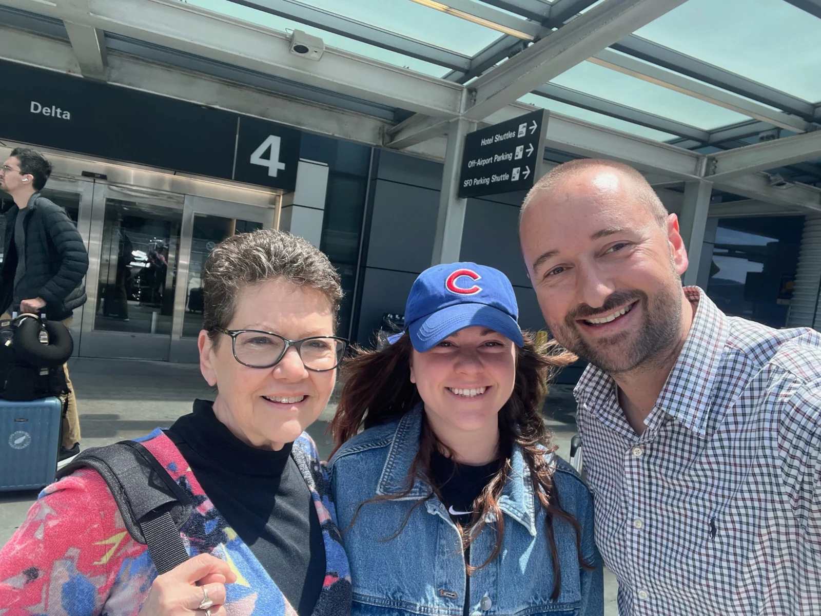 Ride Eaze owner Vince with two travelers at an airport terminal.