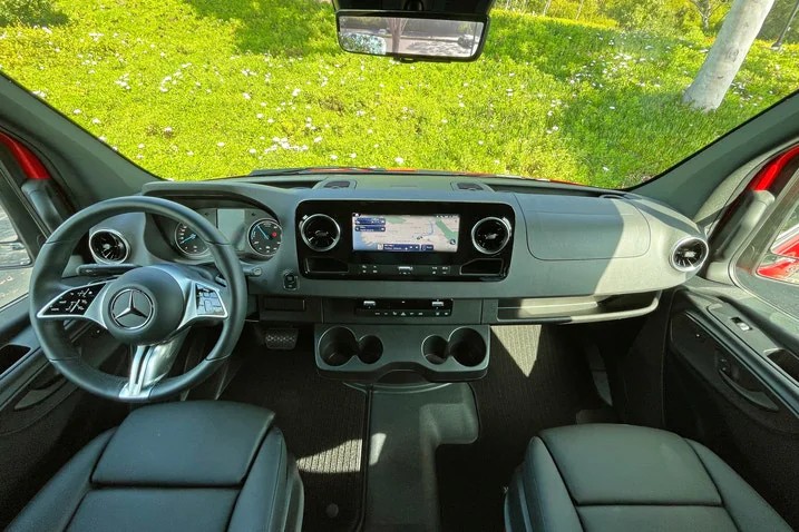 Mercedes Sprinter van front seat with black leather seats and modern infotainment dashboard